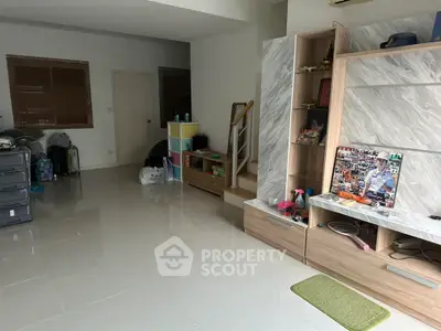Spacious living room with modern decor and staircase, ideal for family gatherings.