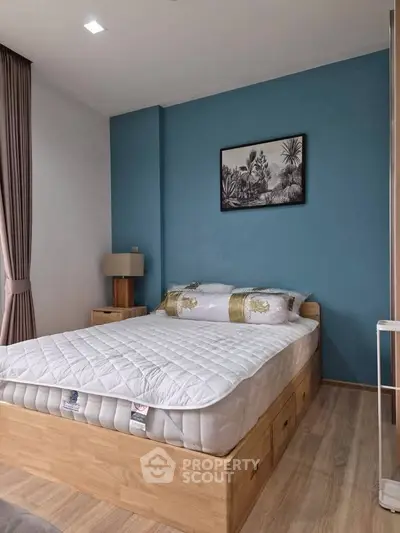 Modern bedroom with blue accent wall and stylish decor