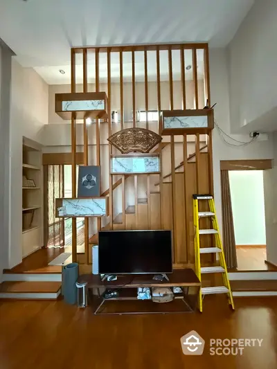 Modern living room with stylish wooden partition and TV setup