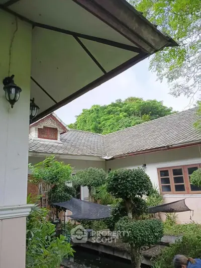 Charming garden view of a traditional house with lush greenery and serene ambiance.