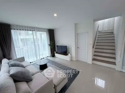 Modern living room with sleek design and natural light, featuring a cozy sofa and stylish decor.