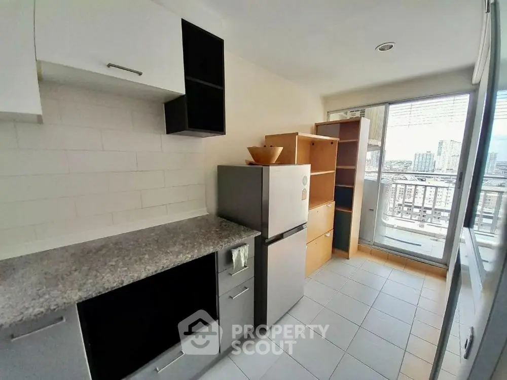 Modern kitchen with city view and ample storage space