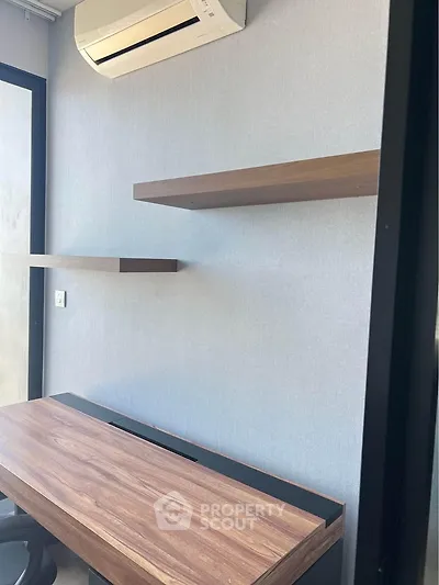 Modern study room with sleek wooden desk and floating shelves