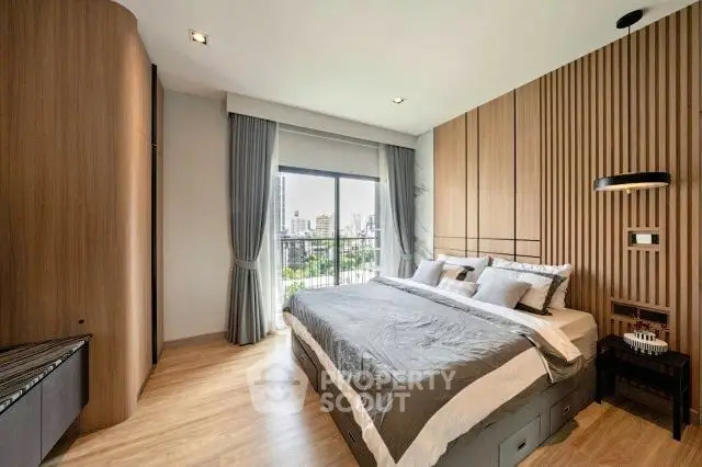 Luxurious bedroom with city view and modern wooden accents, featuring a large bed and stylish decor.