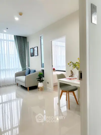 Modern apartment interior with bright living room and cozy bedroom, featuring elegant decor and natural light.