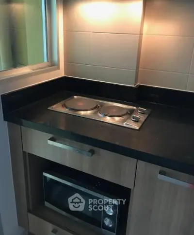 Modern kitchen with sleek electric stove and built-in microwave