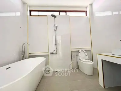 Luxurious modern bathroom with sleek bathtub and elegant fixtures.