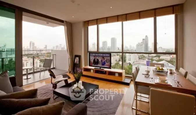 Spacious living room with city view and modern decor in high-rise apartment