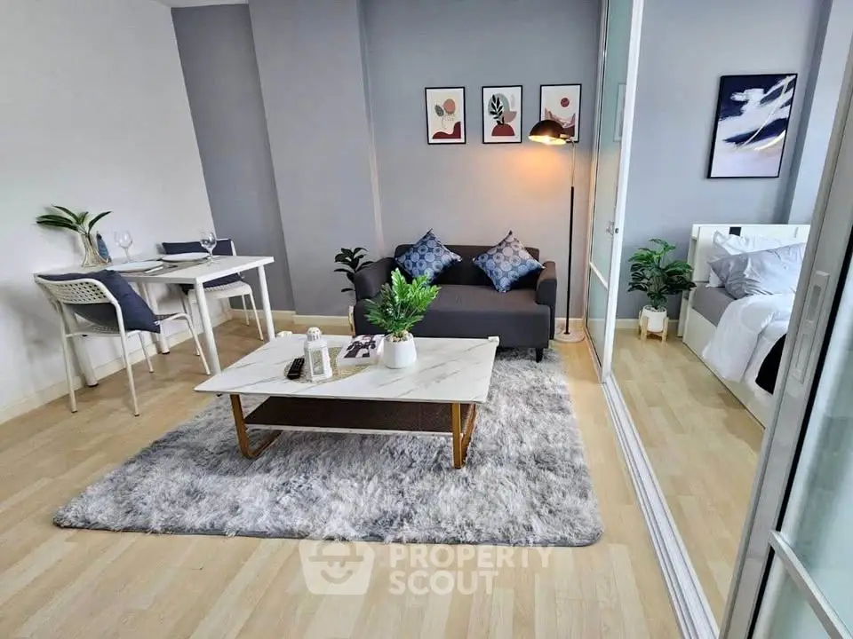 Modern living room with cozy decor and stylish furniture in open-plan apartment.