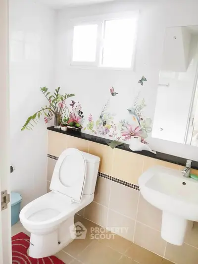 Charming bathroom with floral wall art and modern fixtures