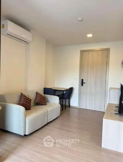 Modern living room with cozy sofa and sleek TV setup in stylish apartment.