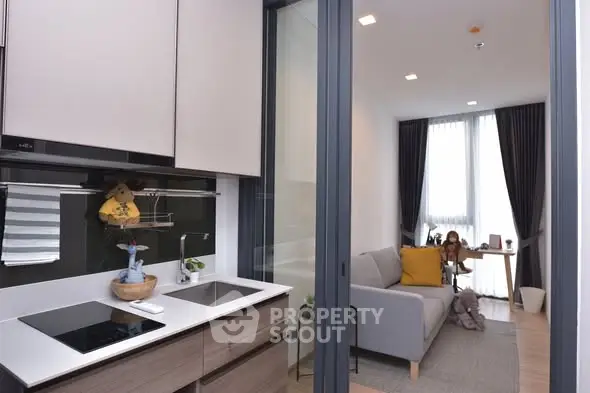 Modern open-layout kitchen and cozy living room with stylish decor