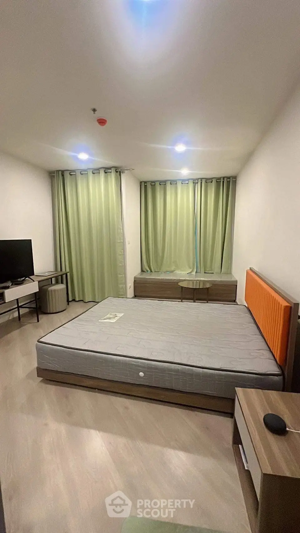 Spacious bedroom with modern furnishings and ample natural light