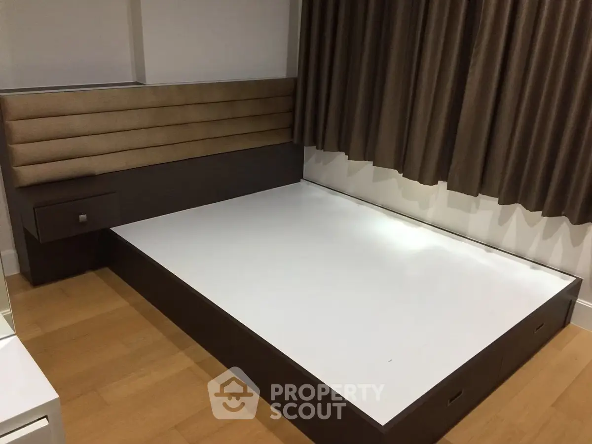 Modern minimalist bedroom with sleek platform bed and elegant curtains