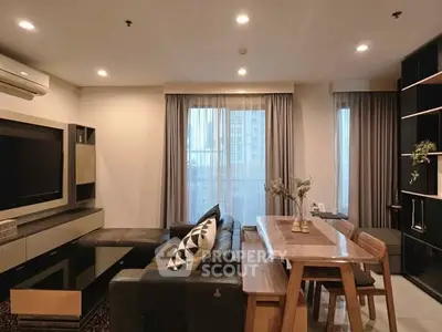 Modern living room with sleek furniture and large windows in a stylish apartment.