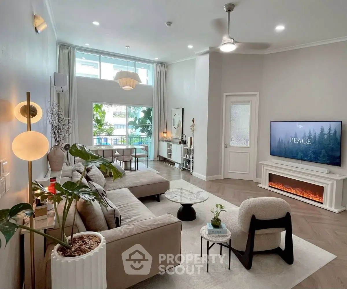 Spacious modern living room with elegant decor and large windows for natural light.