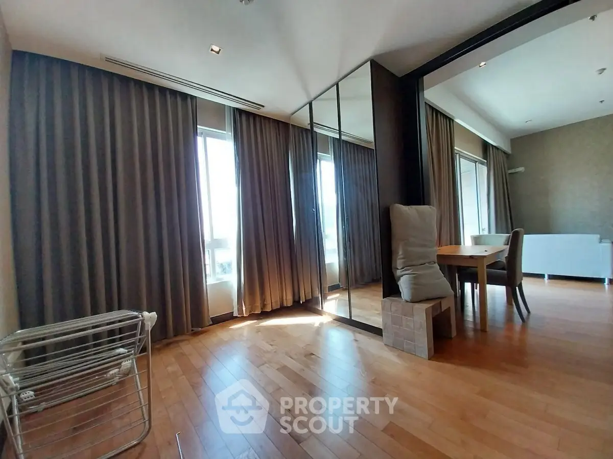 Spacious modern living room with wooden flooring and large windows