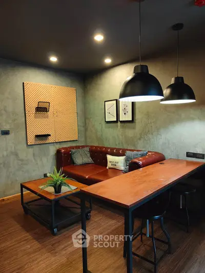 Stylish industrial-style living room with leather sofa and modern lighting