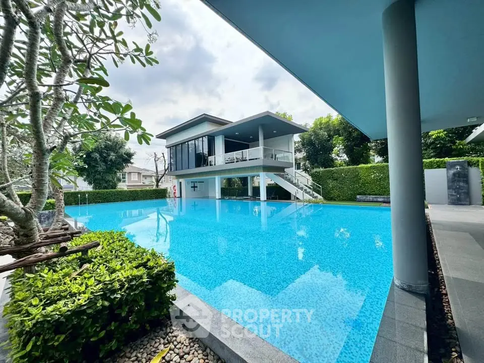 Luxurious modern poolside view with sleek architecture and lush greenery