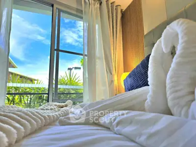 Cozy bedroom with plush bedding and scenic window view