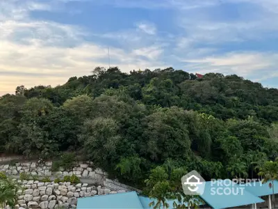 Scenic view of lush greenery and rooftops under a vibrant sky, perfect for nature lovers.