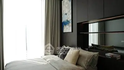 Luxurious bedroom with modern decor and large window for natural light.