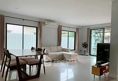 Spacious modern living room with large windows and elegant furniture