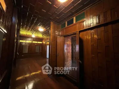 Stunning wooden interior with intricate paneling and warm lighting, perfect for a cozy living space.