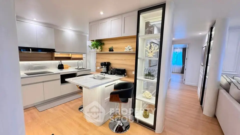 Modern kitchen with sleek design, featuring an island and open shelving, perfect for contemporary living.