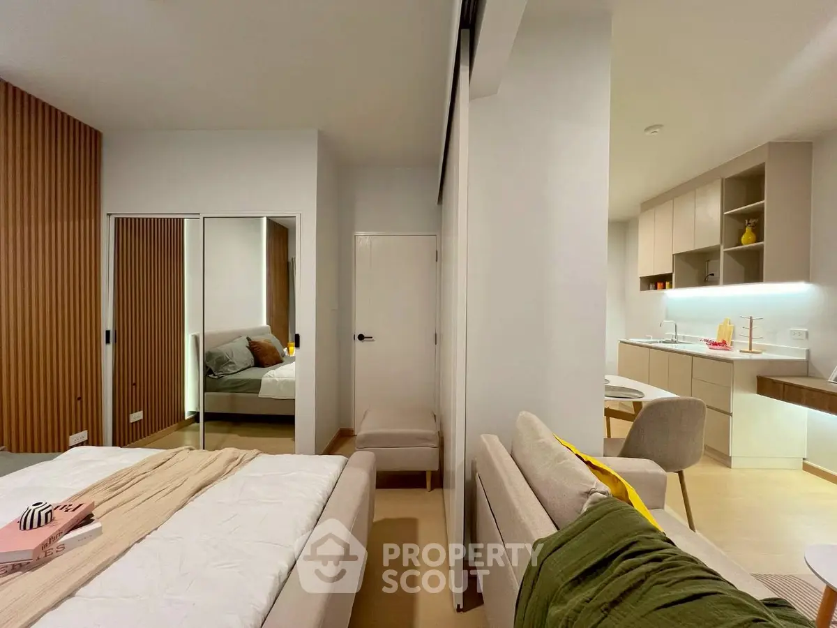 Modern studio apartment with stylish decor and compact kitchen area