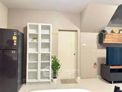 Modern interior with sleek fridge, white cabinet, and stylish TV unit in a cozy living space.