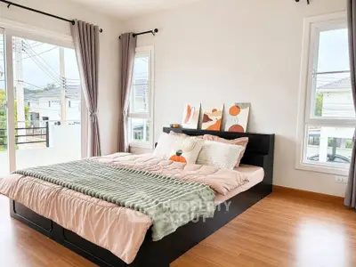 Bright and airy bedroom with large windows and modern decor