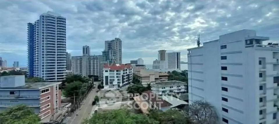 Stunning cityscape view with modern high-rise buildings under a dramatic cloudy sky.