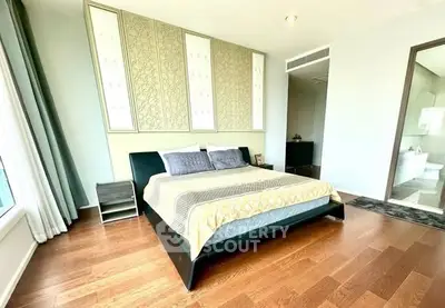 Spacious modern bedroom with elegant decor and hardwood floors