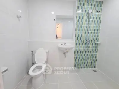 Modern bathroom with sleek white tiles and stylish shower area