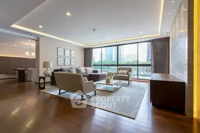 Luxurious modern living room with large windows and elegant decor in a high-rise apartment.