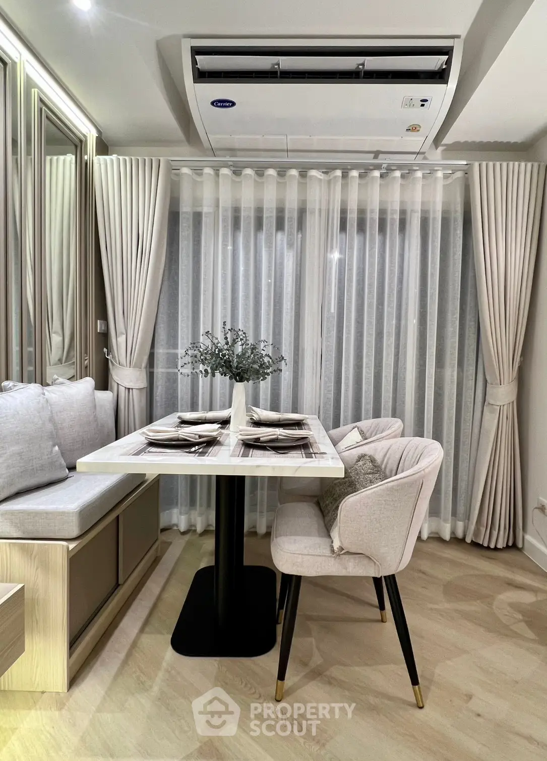 Elegant dining area with modern decor and cozy seating in a stylish apartment.