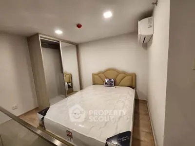 Cozy bedroom with modern design, featuring a comfortable bed and built-in wardrobe, perfect for urban living.