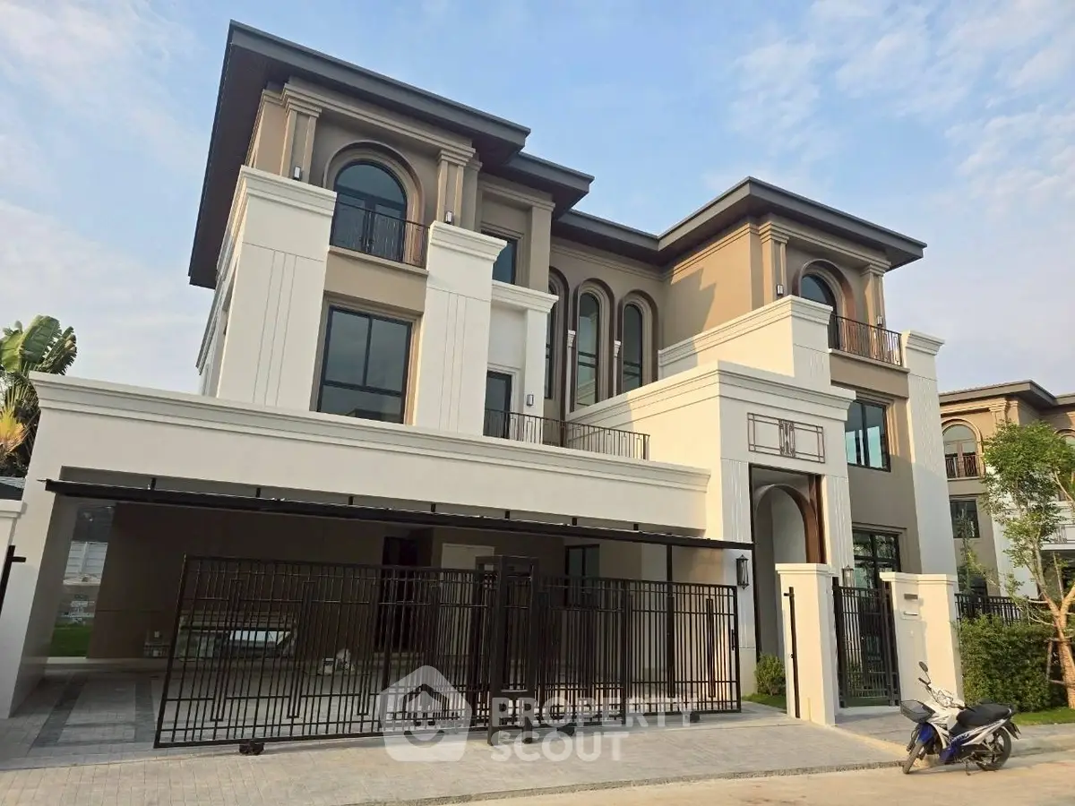 Luxurious modern three-story house with elegant facade and spacious driveway, perfect for upscale living.