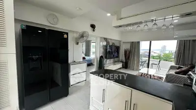 Modern open-layout kitchen and living room with city view and stylish decor