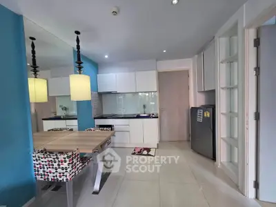 Modern kitchen with vibrant blue accent wall and stylish dining area