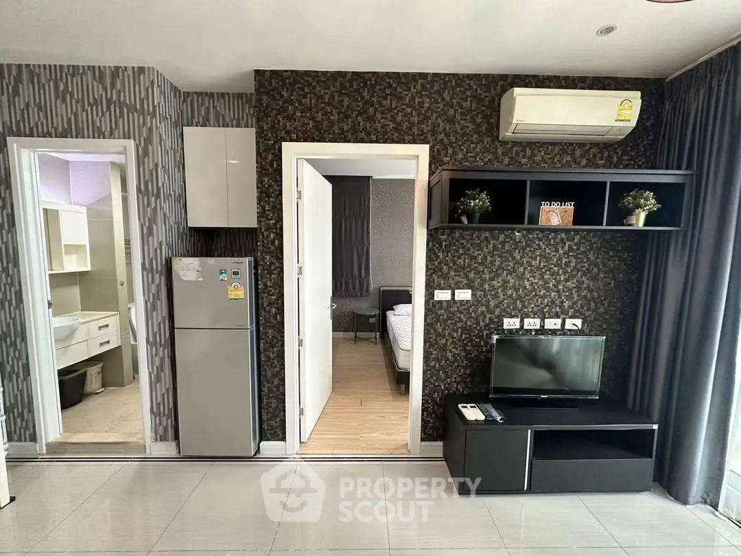 Modern apartment interior with stylish decor, featuring a cozy living area and sleek kitchen appliances.
