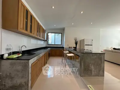 Spacious modern kitchen with sleek countertops and open layout, perfect for entertaining.