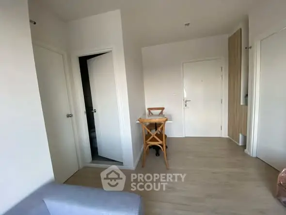 Modern apartment interior with wooden flooring and minimalist furniture