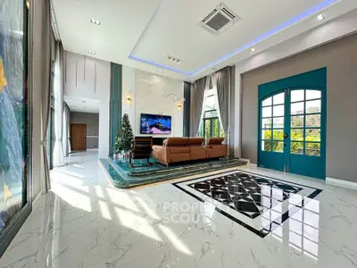 Luxurious living room with elegant decor and large windows offering natural light
