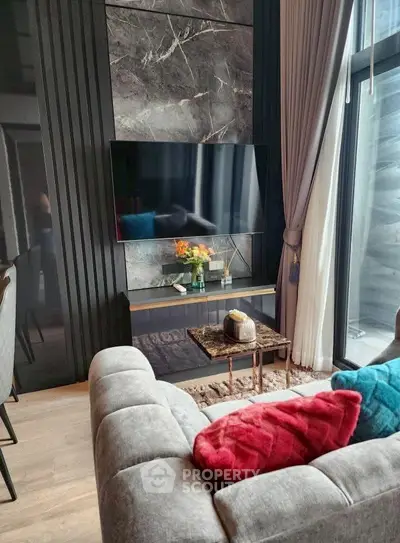 Luxurious living room with modern decor and large window for natural light.