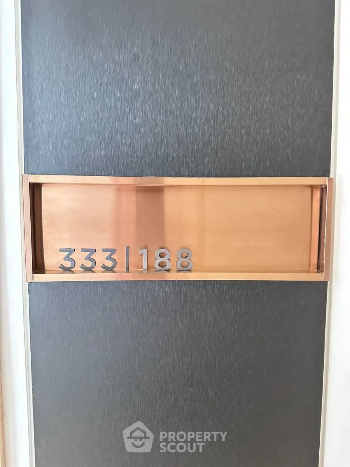Modern apartment door with sleek design and unit number display