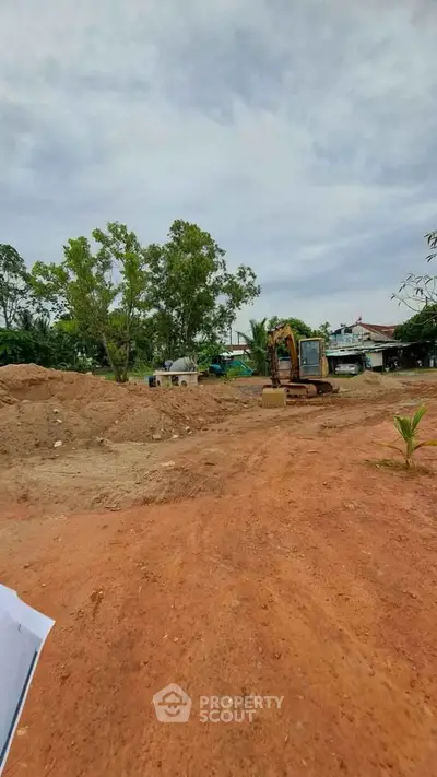 Expansive construction site with excavator, ready for new real estate development.