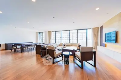 Spacious modern living room with large windows and elegant furnishings