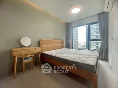 Modern bedroom with wooden furniture and large window in urban apartment